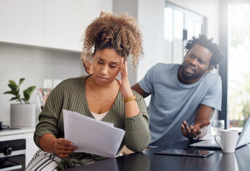 A couple having an argument while going over their finances Concept for blog topic: How to Get an Ex-Spouse Off a Mortgage.
