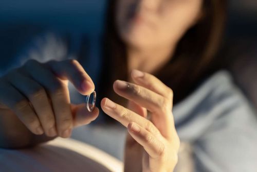 Woman removing her wedding ring considering getting an annulment