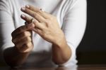 Hands of caucasian female who is taking off her wedding ring. Visual concept for Divorce Litigation blog series titled: Understanding the Divorce Litigation Process in Maryland.