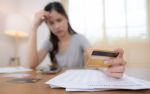 Stressed woman preparing a financial statement. Visual concept for a divorce blog discussing the importance of accuracy in a divorce financial statement.