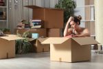 sad woman packing boxes
